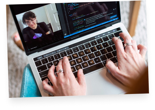 Image of a someone on a macbook pro writing code